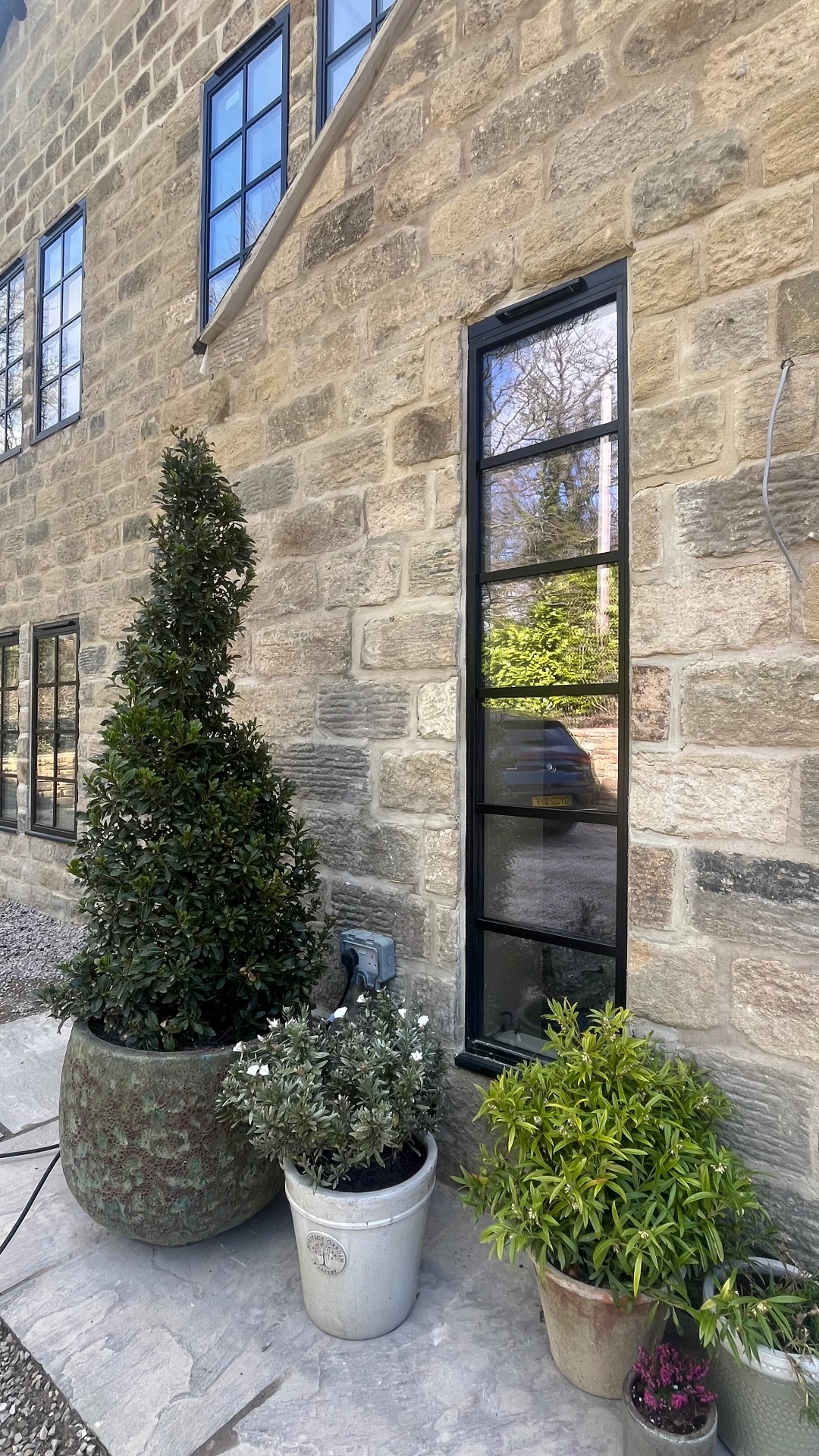 Full-height narrow Heritage light beside a rear entrance