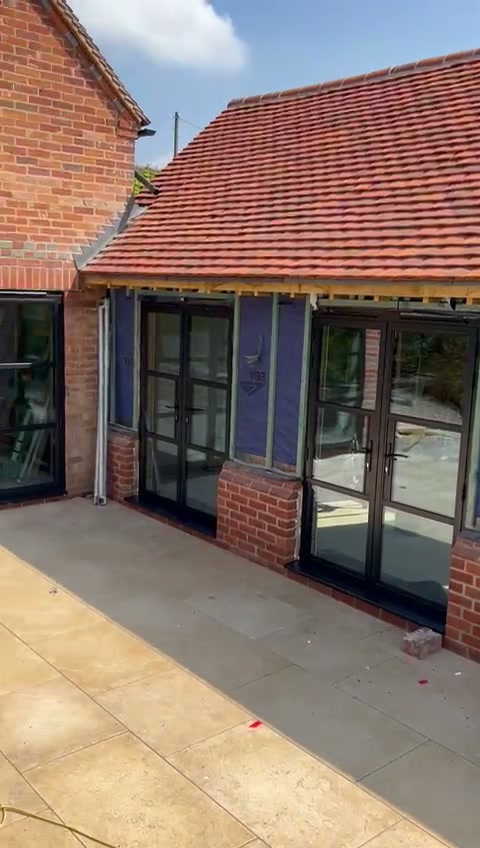 Clay-tiled roof carried over the continuous glazed elevation