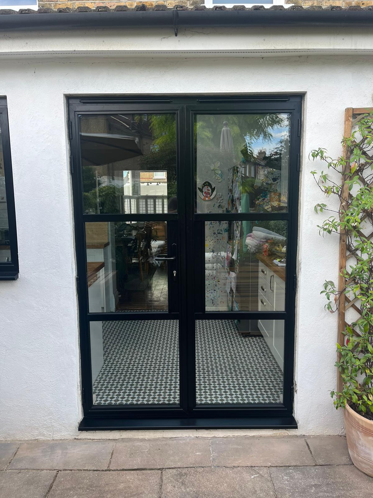 Black steel-look French doors to a rendered elevation