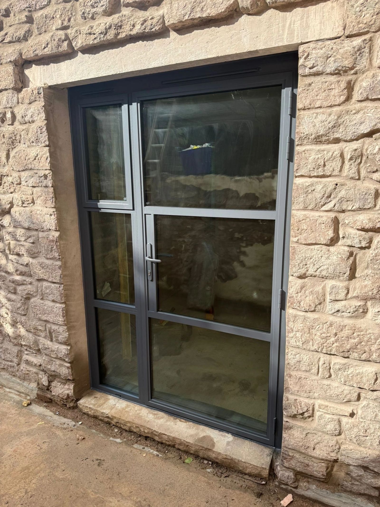 Slim aluminium frames in a stone elevation