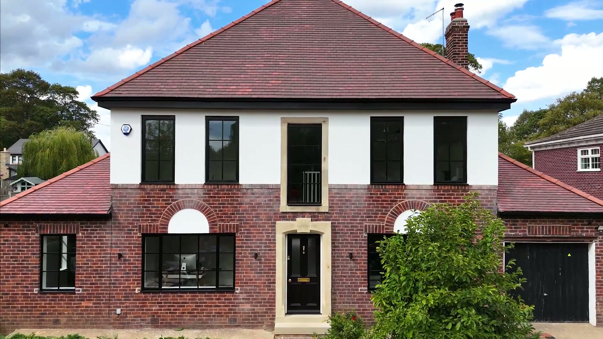 Brick and render frontage with arched-head ground-floor openings
