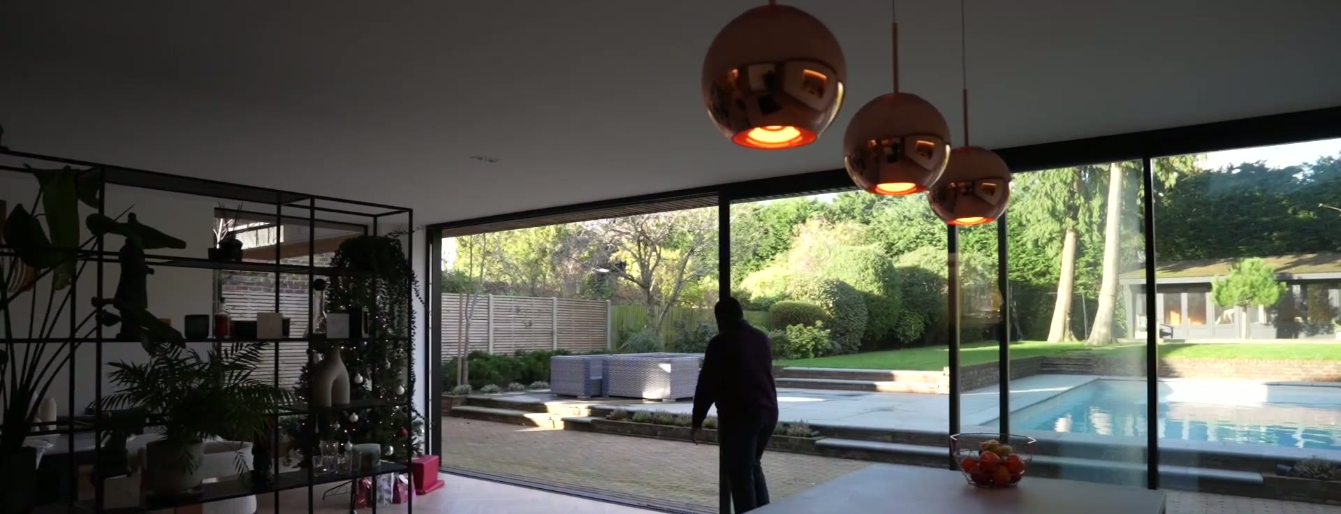 Rear elevation in low sun, glazing aligned with the canopy and piers