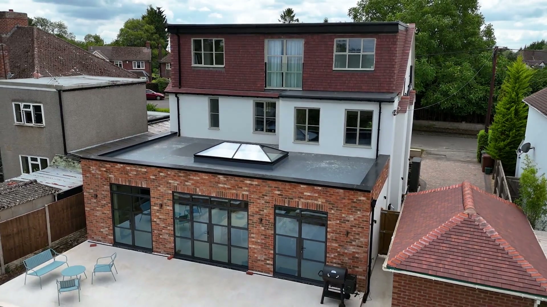 Approach over the village rooftops to the remodelled house
