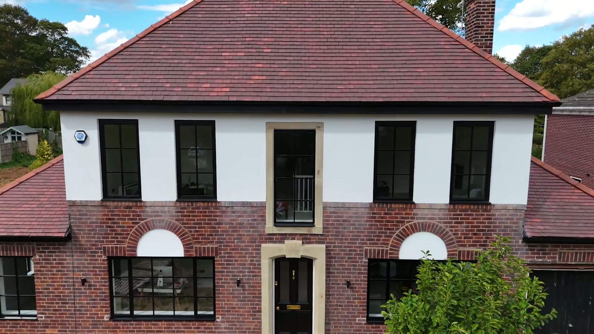 Matt black frames against red brick and white render, whole-house remodel near Penrith — Aluminium Windows by Windows in the Lakes