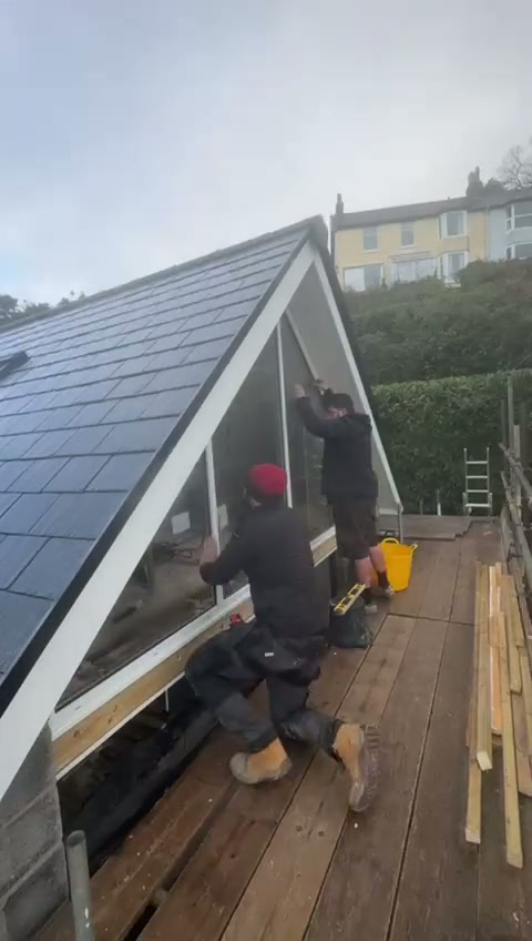 Plumb, level and diagonals are re-checked at the apex; the raked joint is factory cut to the surveyed pitch, never trimmed on the deck.