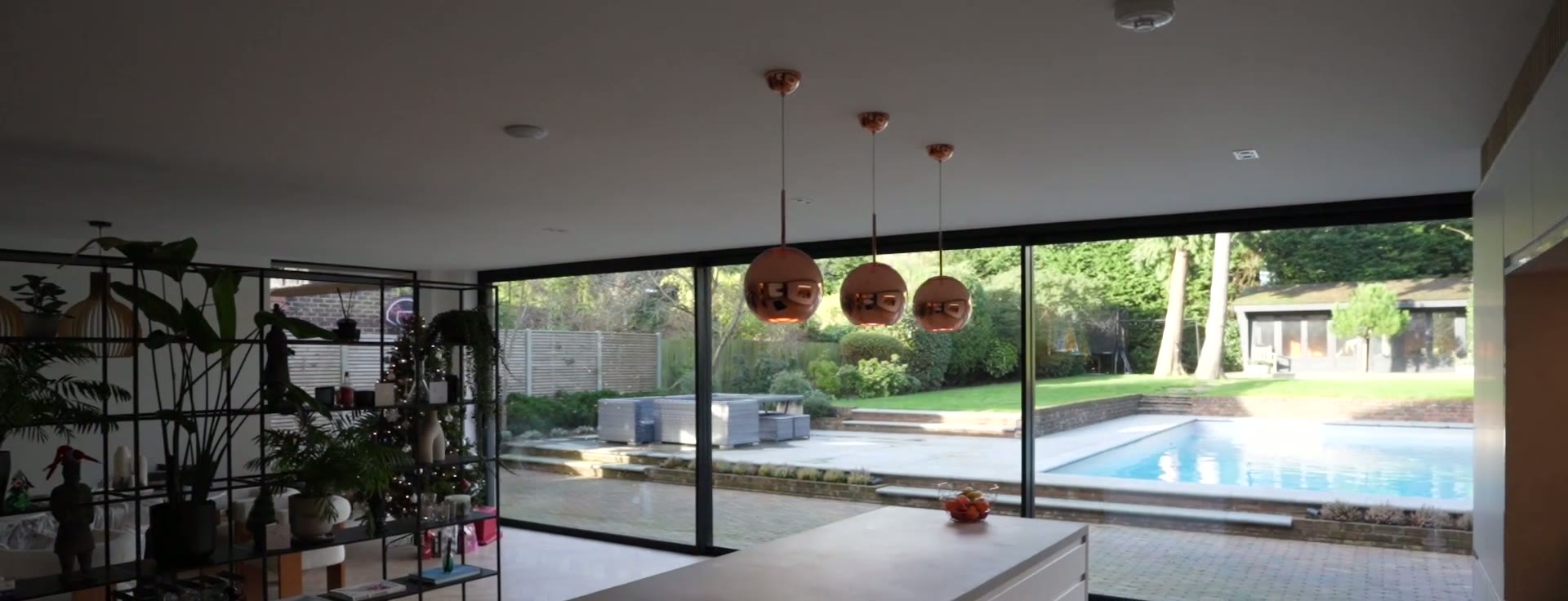 Looking out through the open sliding wall to the pool terrace