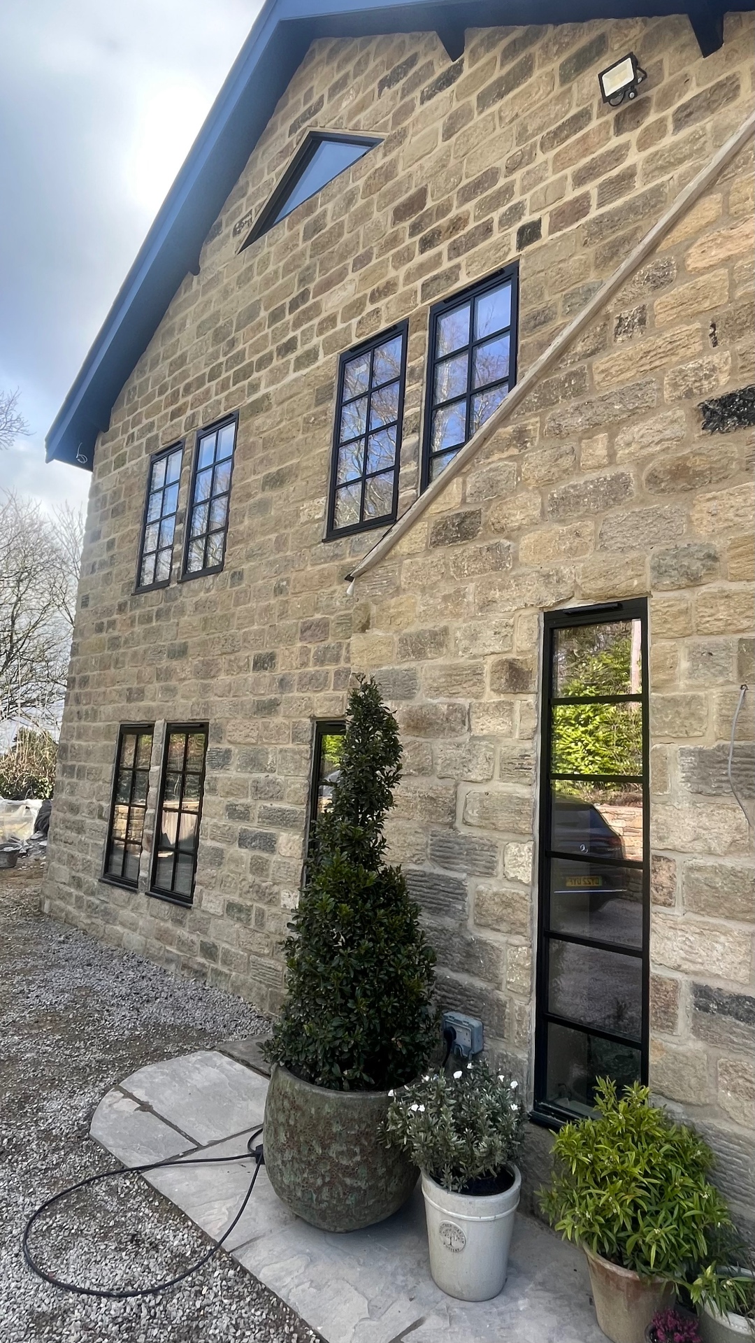 Staggered Heritage openings across a stone side elevation