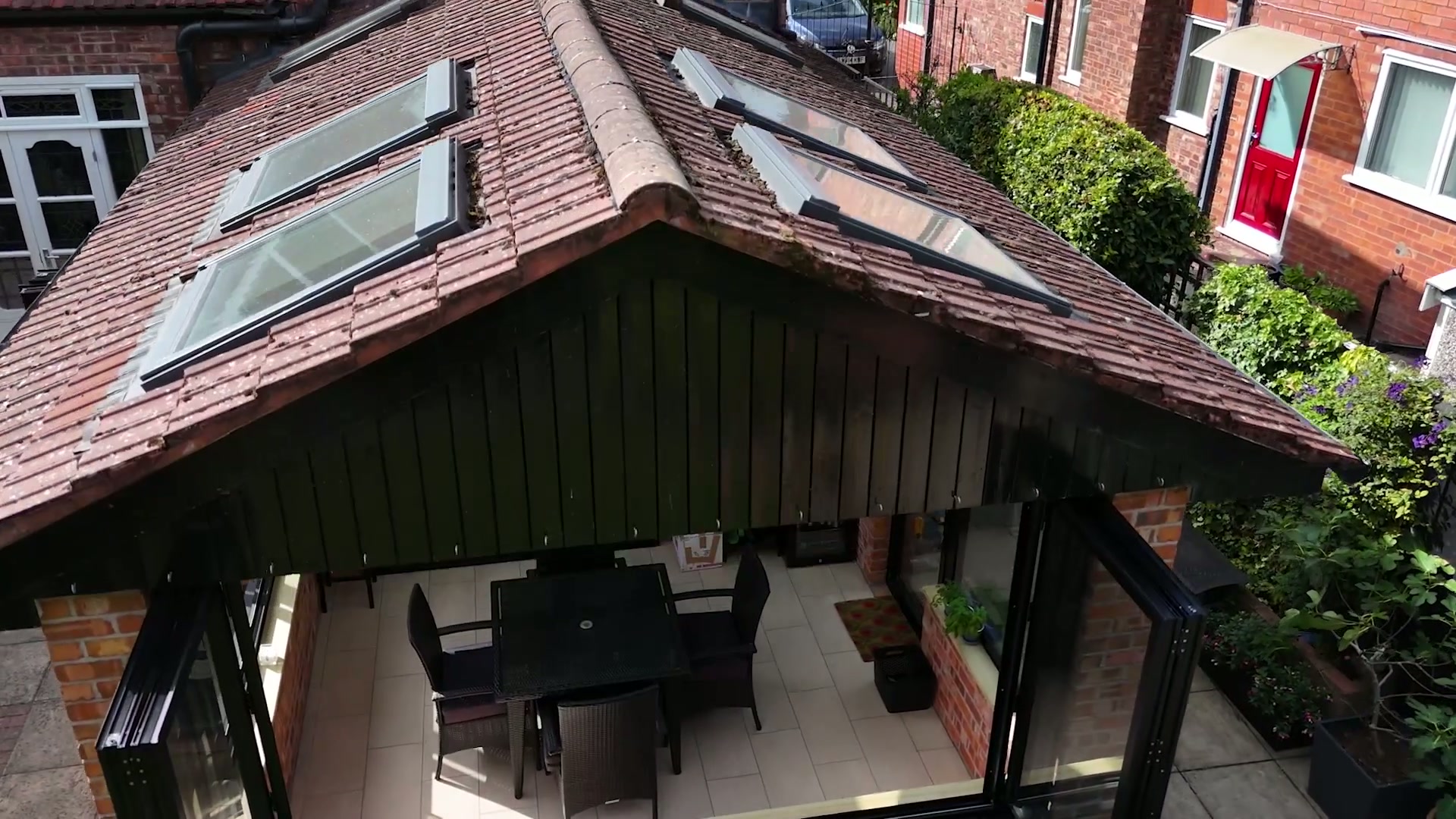 Corner bay — jet black frames carried between brick piers