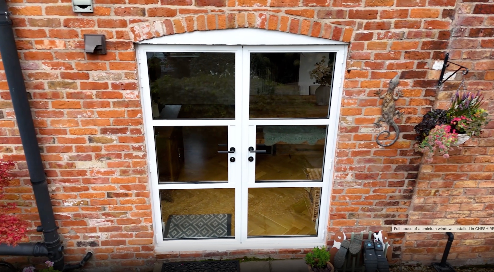 Aluminium French doors set into a brick arch