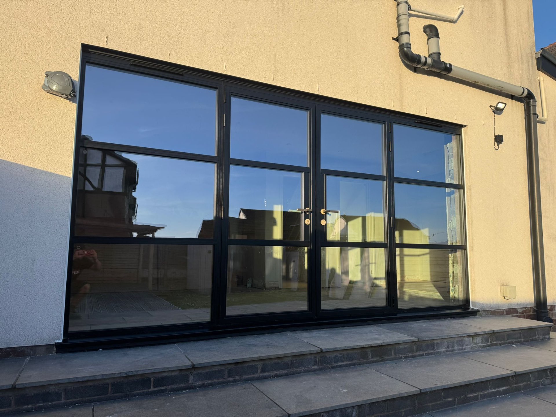 Steel-look screen with French doors and transom lights